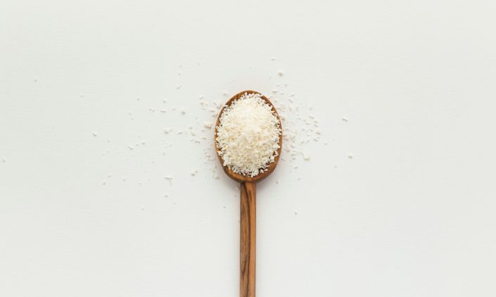 Wooden spoon with a pinch of salt