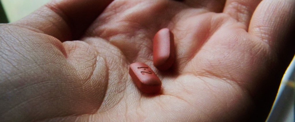 Pills in a hand, responding to illness