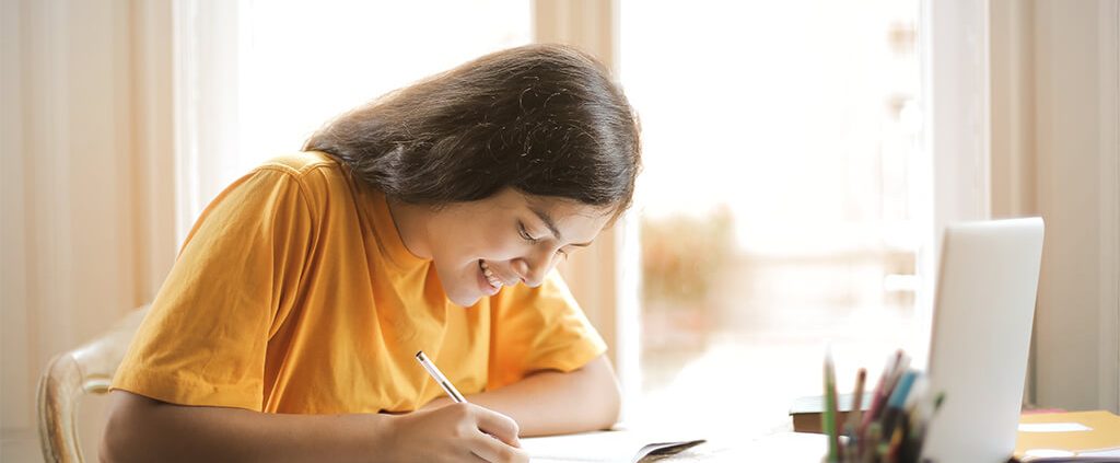 Image of girl writing in her notebook