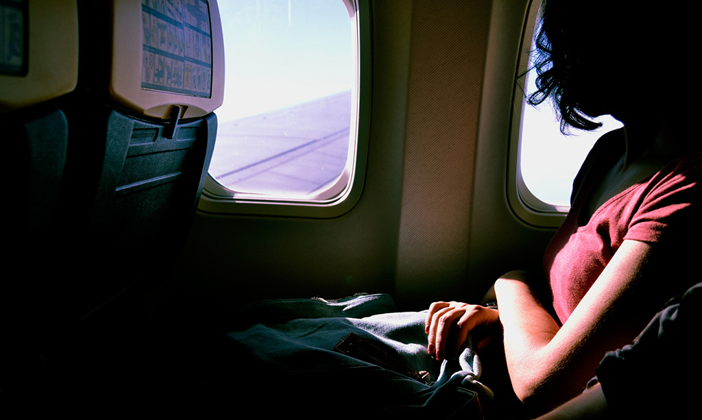 Female looking out of the window on an airplane
