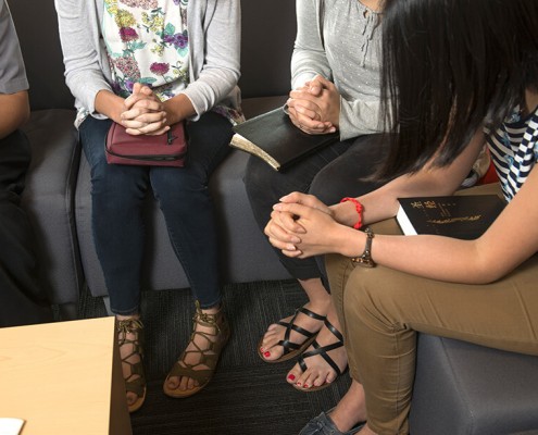 Group of Christians praying with bibles in their laps