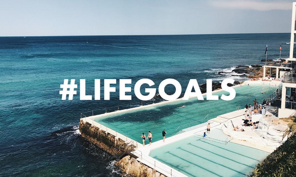 Pool resort on the each with text overlay of #lifegoals