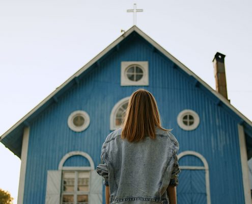 image of lady looking at a front entrance of a church