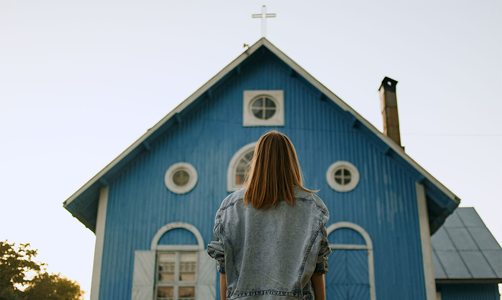 image of lady looking at a front entrance of a church
