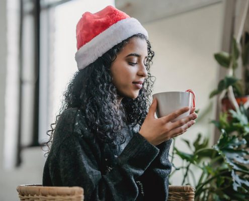 A girl is enjoying a cup of hot chocolate in Christmas