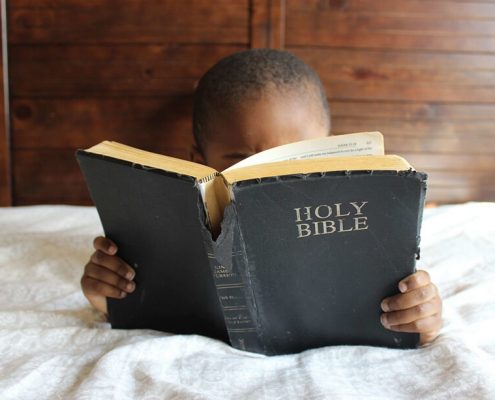 A child is reading bible
