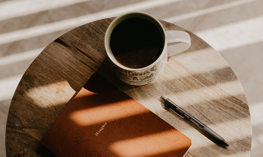 Image of a journal and coffee mug