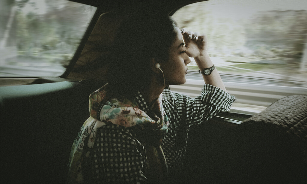 Woman looking out a car window