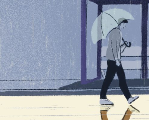 A guy is walking on a rainy day and his reflection