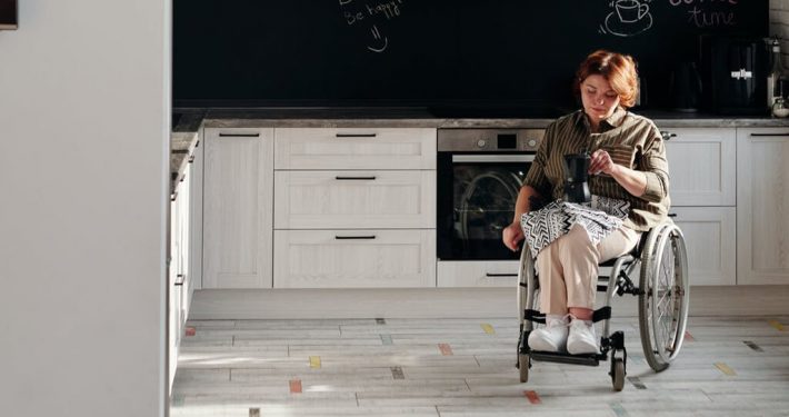 a woman sitting on a wheelchair is feeling sad and lonely