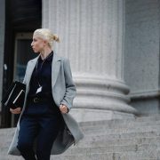 An ambitious working woman is walking out from the office building
